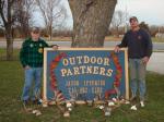 2012 Owner Right and Gary Left stand with sign and some racks